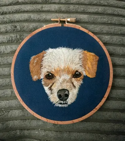 Custom terrier portrait embroidery hoop on navy fabric
